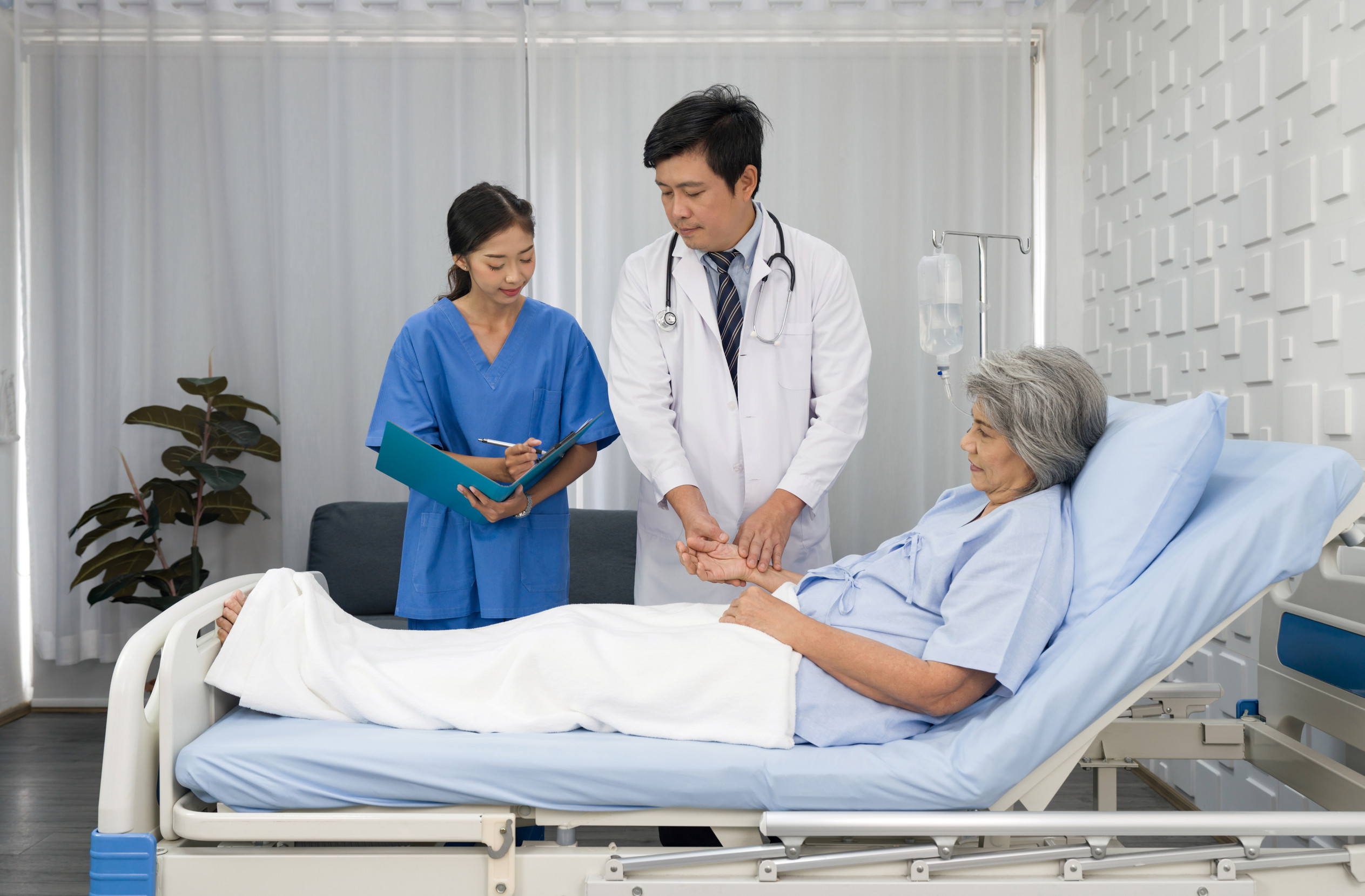 Senior female patient and doctor. Asian doctor with stethoscope